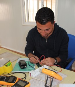 Basel Noserat learns to repair mobile phone at Za’atri refugee camp in Northern Jordan. 