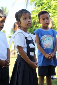 The school day starts with The Lord's Prayer, the National Anthem and flag raising. Gellian Maragrag has already learned these in Kinder (preschool).