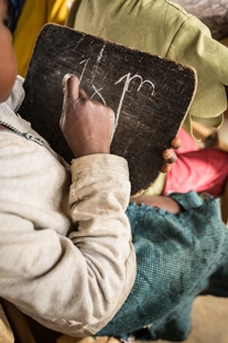 The end of the year exams are underway in the first grades of the school repaired by FCA. Today is the turn for the written exams on mathematics and French language. Most of the children do not have paper, so the exams are done on chalk boards.