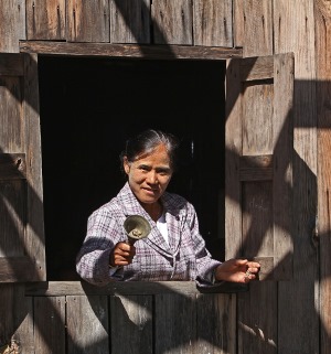 Village school’s head teacher Daw Om Yawmg rings her bell and calls children to school.