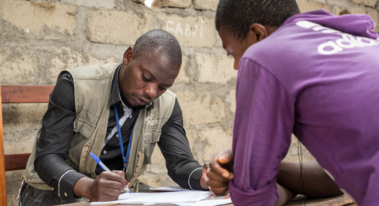 ETN employee David Ngabo taking registrations from new students at the Masisi education centre. Photo: Ville Asikainen.