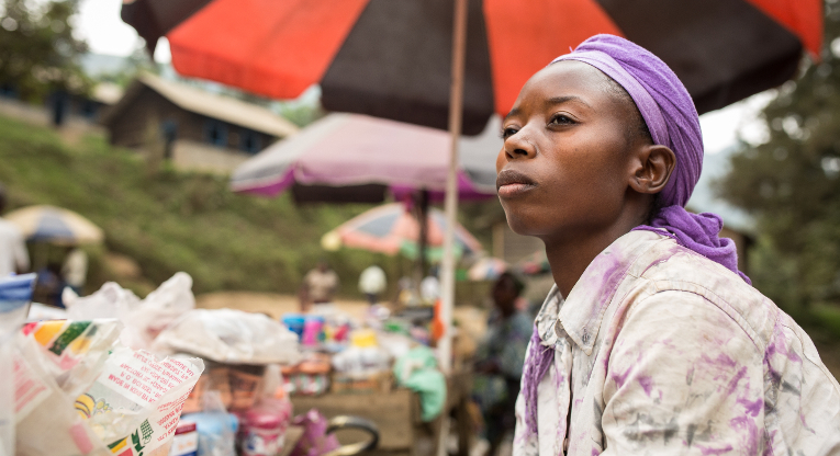 Tumaini Mongali selling various products in Masisi. She has received support from the Women’s Bank to start her business and she has received education at the ETN centre. Photo: Ville Asikainen.