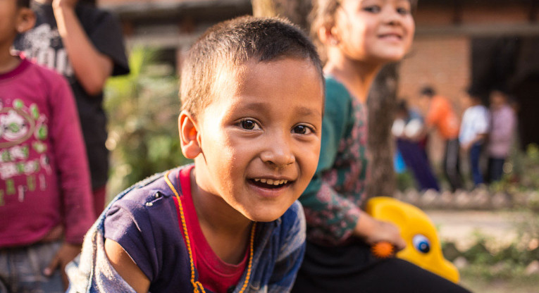 Play is a good way to help a child recover from trauma. Ritesh Khadka seems to enjoy posing for pictures as much as playing with friends. Photo: Antti Helin