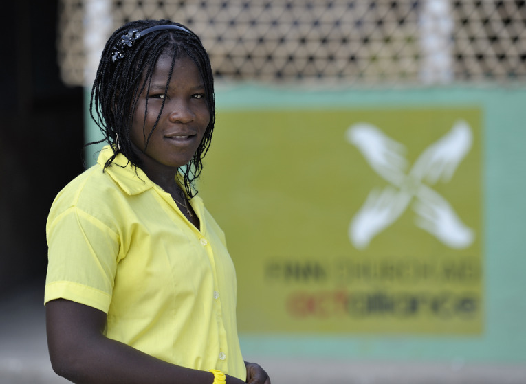 Kathia Amy, a 17-year old in Grand-Goave, Haiti, one year after the January 2010 earthquake. She is pictured here in front of her school, the College Les Freres Milord, which was rebuilt after the quake by Finn Church Aid. Photo: Paul Jeffrey.