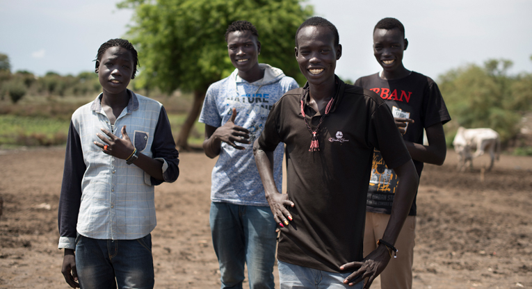 Bollein Daki (in front) and his friends from the Kurenen age-set are able to move freely in the town of Pibor after the peace process. Before the peace, they were engaged in bloody fighting against other age-sets and were forced to hide out of town. Photo: Hugh Rutherford.