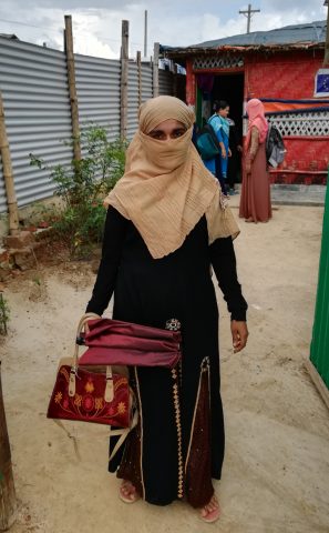 Fatima leaving the Women and Girls safe space to go home to her 3 year old son.