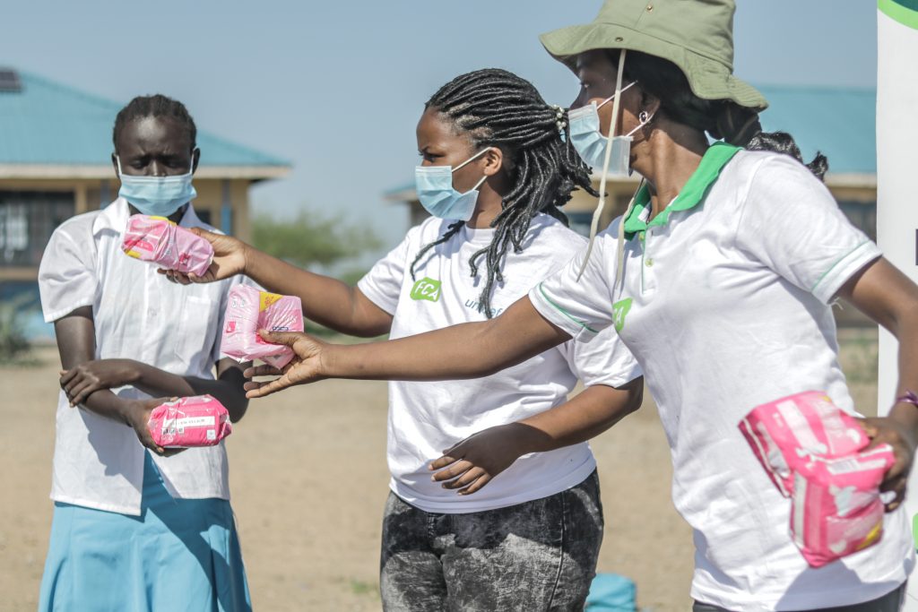 Catherine Angewenyi from FCA distributing sanitary pads at Kalobeyei refugee settlement.