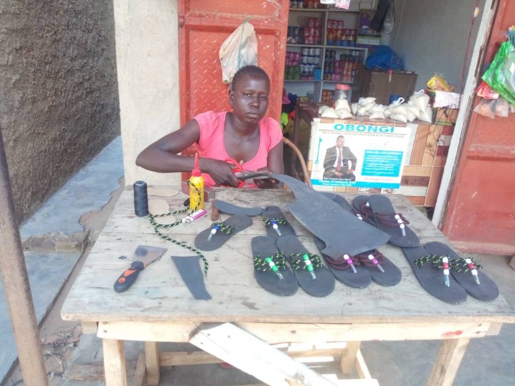 Esther Kuyang making sandals in her workshop.