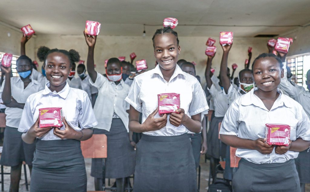 school girls holding sanitary bads