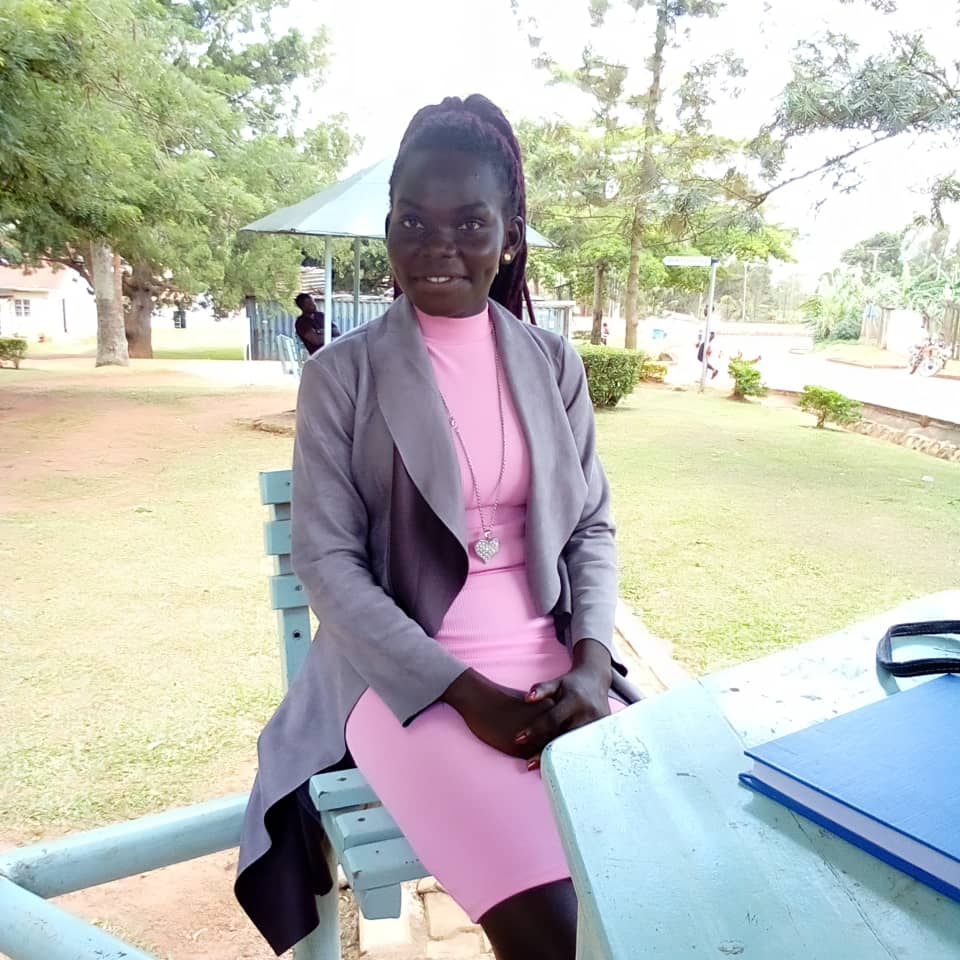Gloria Kani, a refugee from South Sudan, sits at a table during an interview about her FCA Scholarship. Finn Church Aid empowers refugees with education scholarships for refugees. 