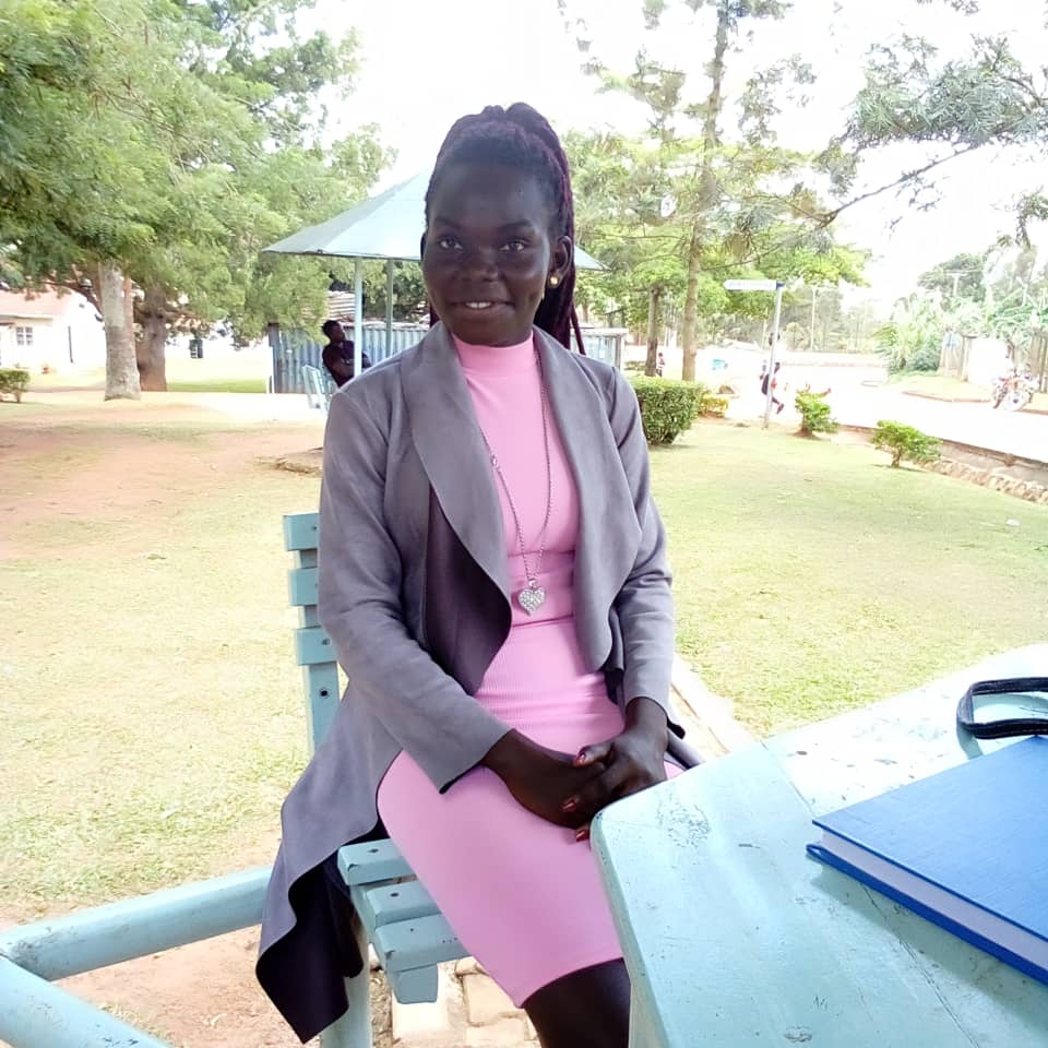 Gloria Kani, a refugee from South Sudan, sits at a table during an interview about her FCA Scholarship. Finn Church Aid empowers refugees with education scholarships for refugees.