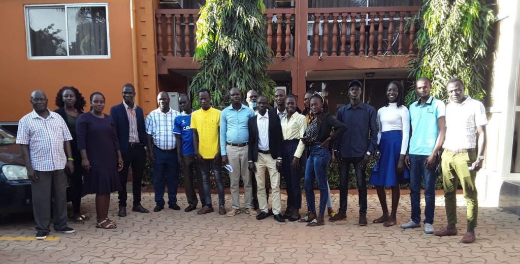 Students studying with FCA education scholarships pose for a photo outside their university campus in Uganda. Finn Church Aid empowers refugees with education scholarships for refugees. 