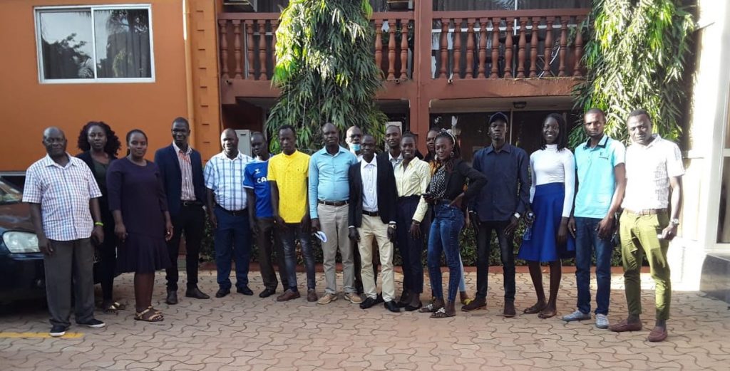 Students studying with FCA education scholarships pose for a photo outside their university campus in Uganda. Finn Church Aid empowers refugees with education scholarships for refugees.