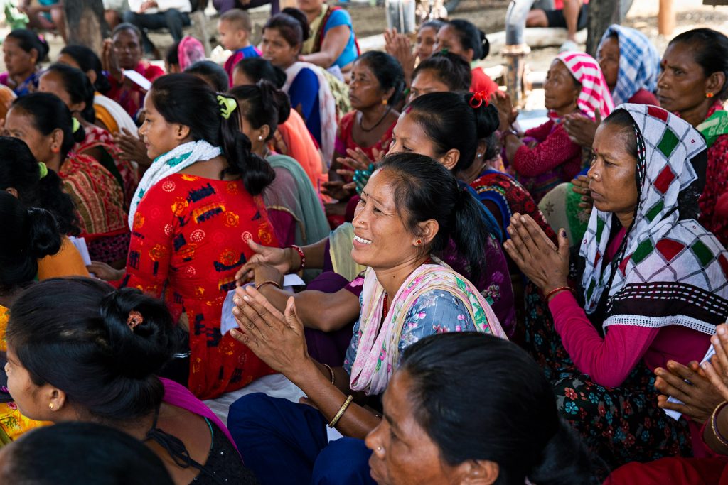 Women sit on the ground. 