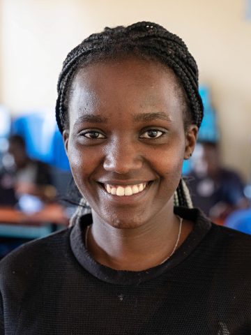 A woman smiles at the camera