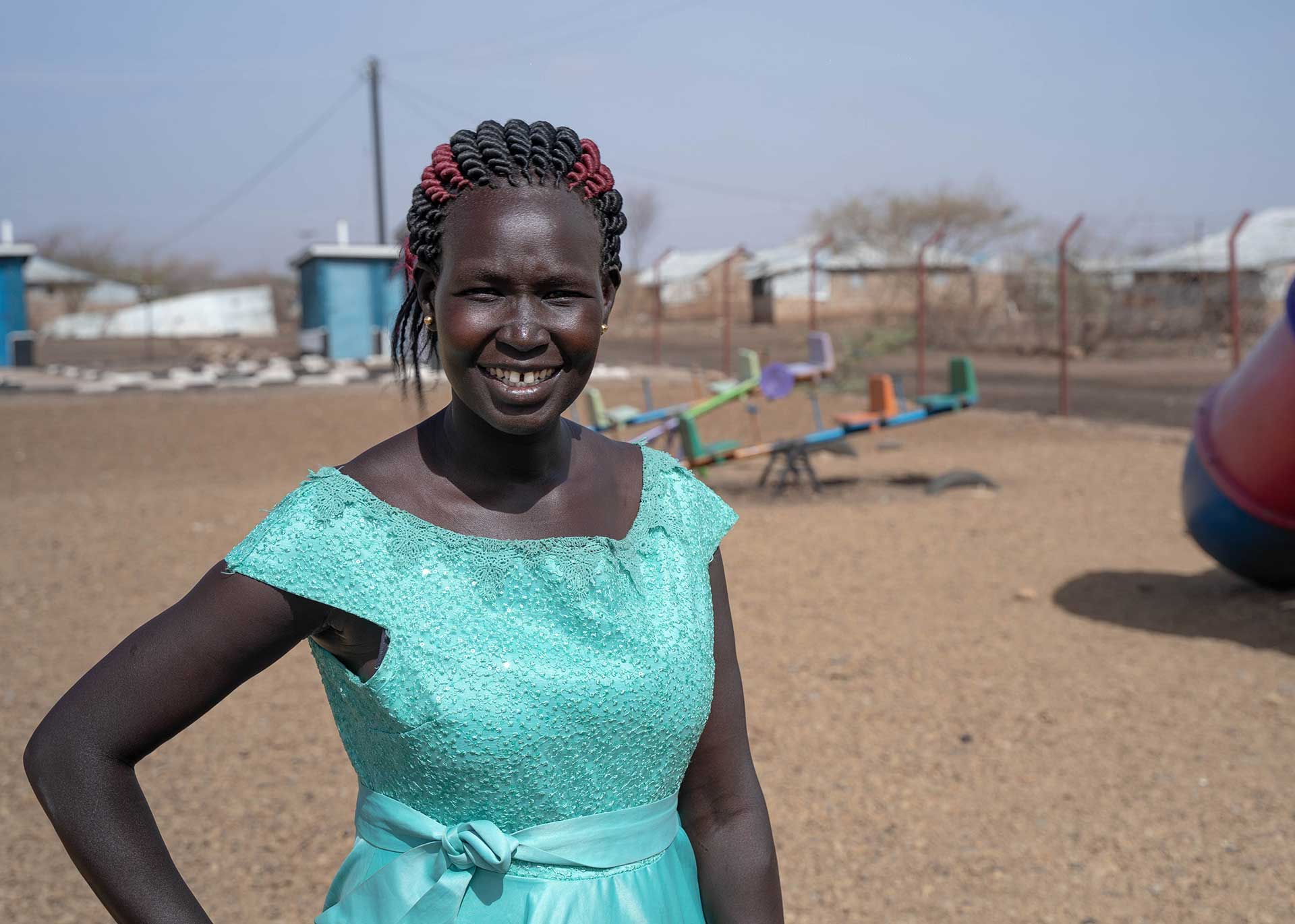A Kenyan woman poses for a photograph. 