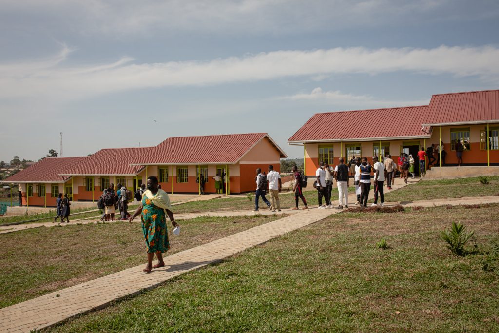 A school yard with adults and children walking
