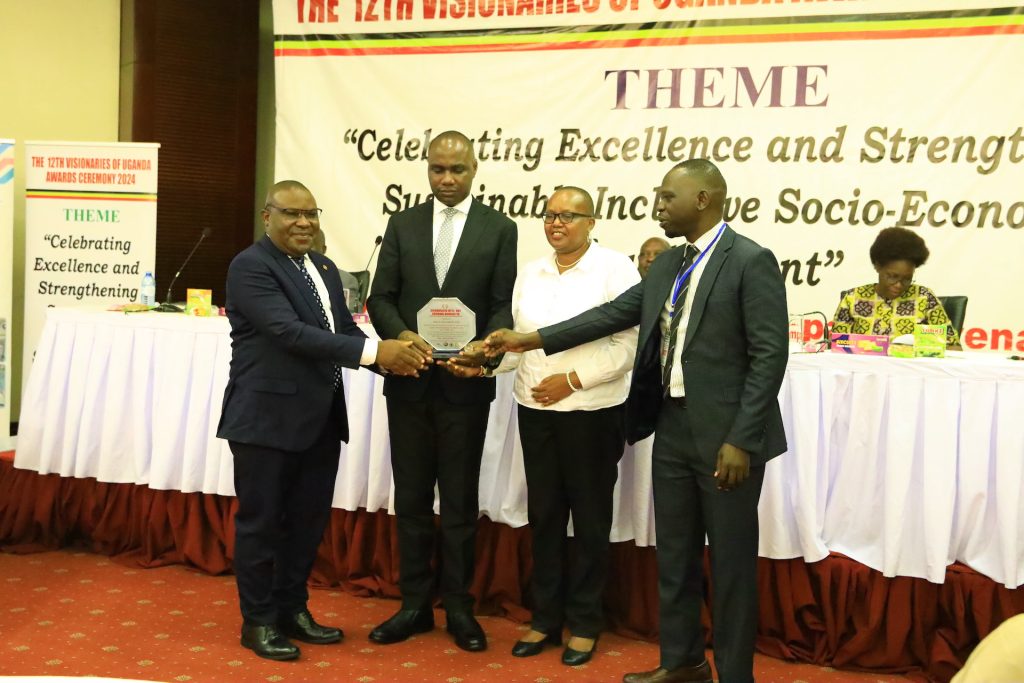 Four men holding an awards plaque