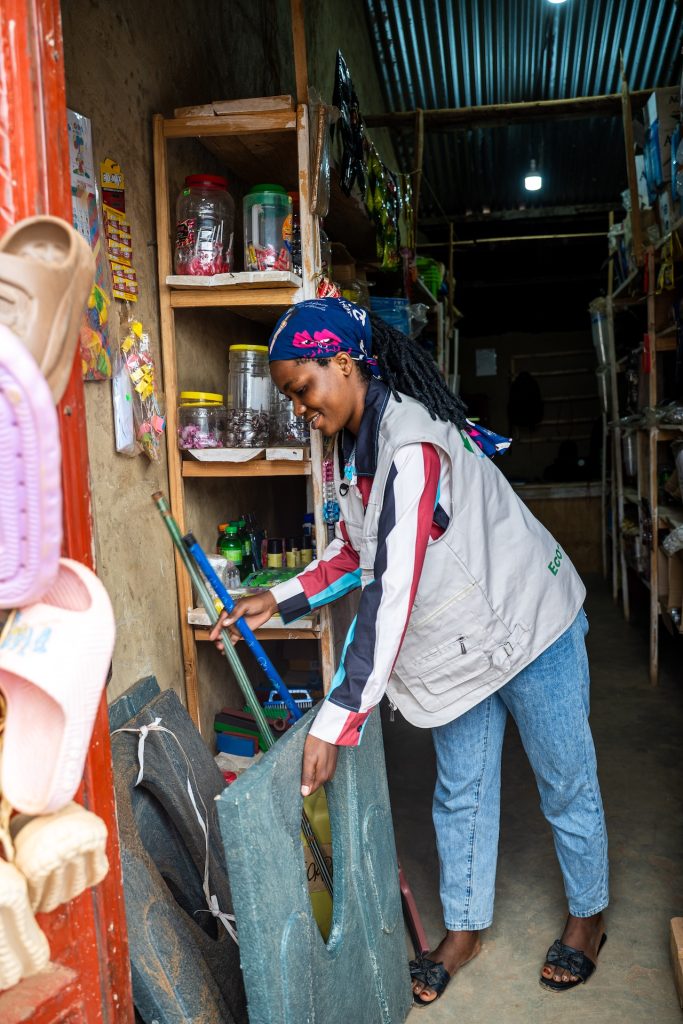 A woman moving a toilet seat made of recycled materials.