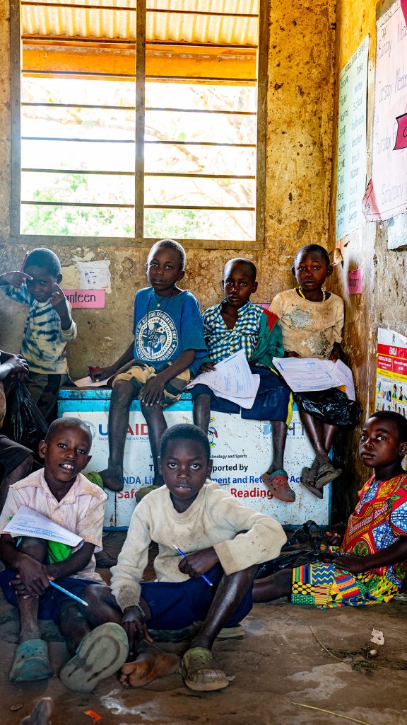 Children sitting very closely in class