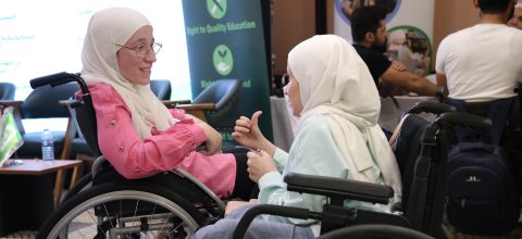 Two women in wheelchairs talking