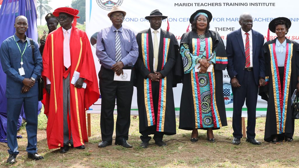 Seven people standing in a row dressed in festive clothing.