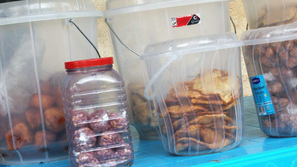 Different baked goods in plastic jars on a table.