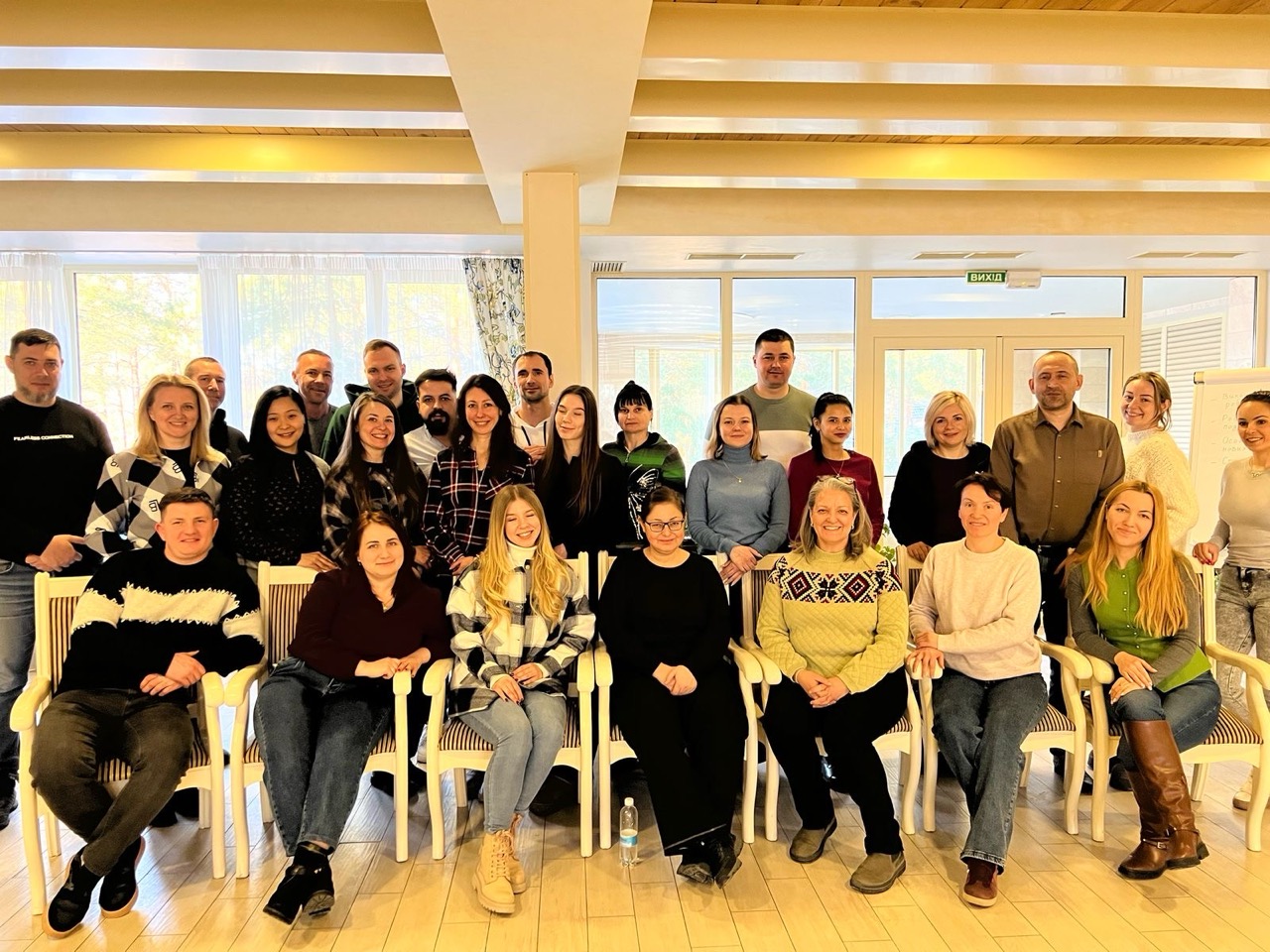 A group of people pose for a photo in an office
