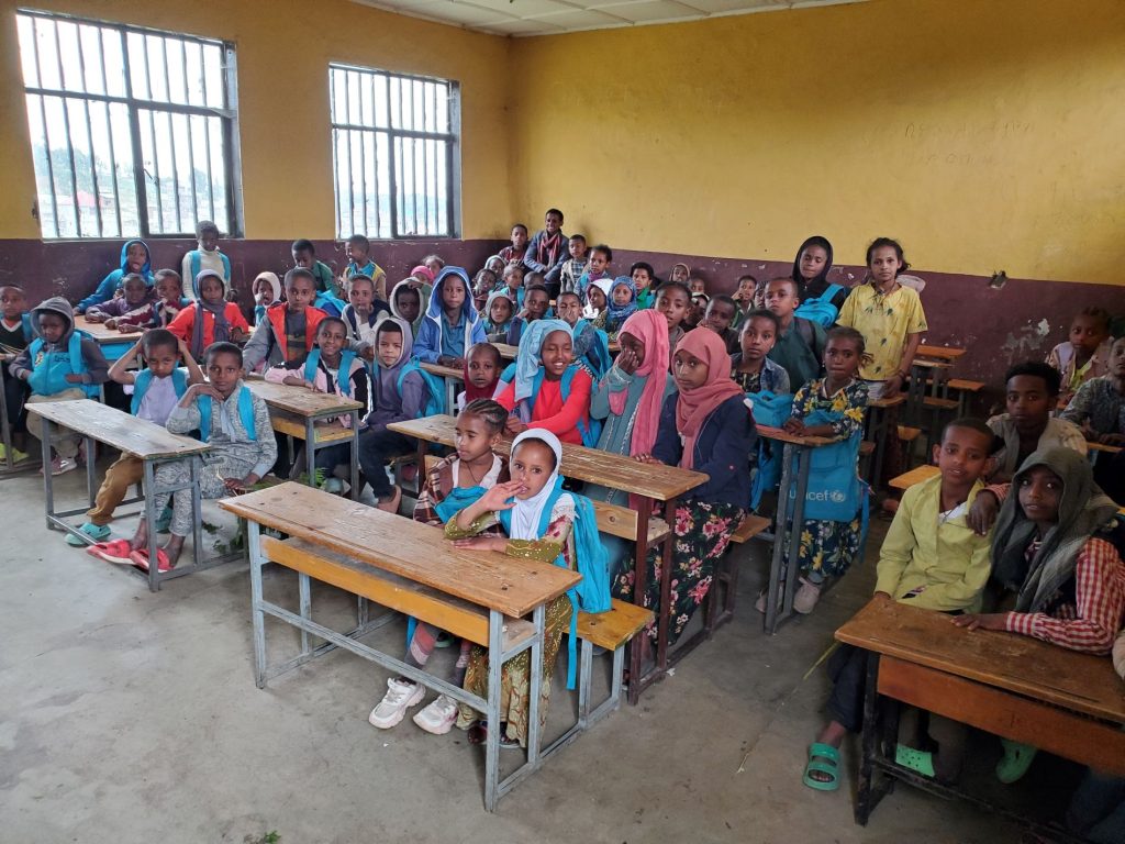 Children in a yellow classroom.