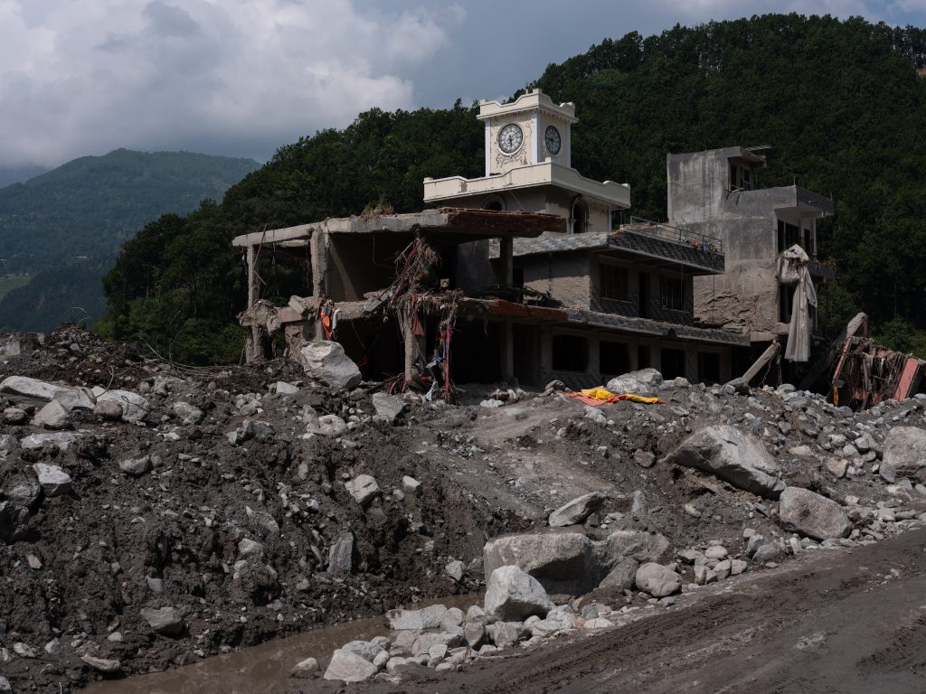 A ruined building with a clock tower on top.